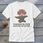 White t-shirt with anvil graphic, blooming branches, and text "FORGED IN FIRE ROOTED IN STONE".