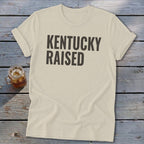 Cream t-shirt with "KENTUCKY RAISED" text and a glass of iced tea.