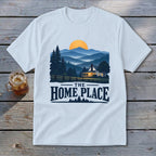White t-shirt with a graphic of a house in the mountains and the text "The Home Place".