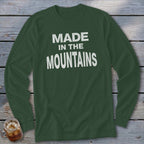 Dark green long-sleeve shirt with "MADE IN THE MOUNTAINS" printed in white.