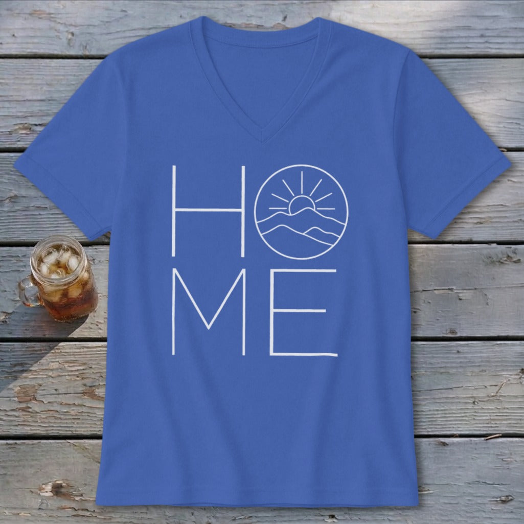 A blue v-neck t-shirt with a white graphic spelling HOME, featuring a mountain sunrise.