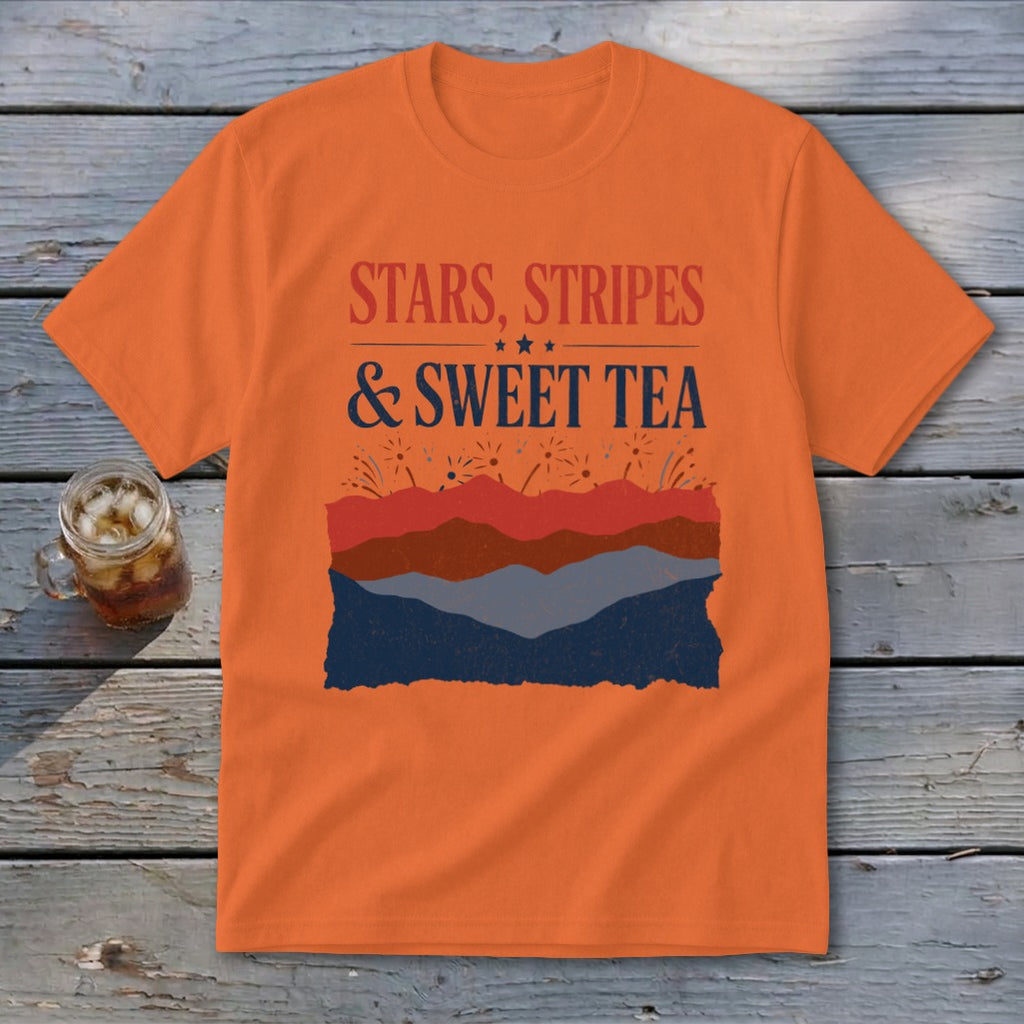 An orange short-sleeved t-shirt featuring the text STARS, STRIPES, AND SWEET TEA above mountain graphics.
