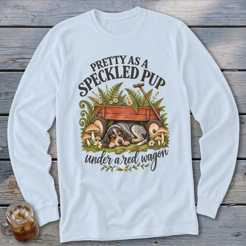 Long sleeve shirt with a speckled pup sleeping under a red wagon.