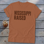 Orange t-shirt with brown text "MISSISSIPPI RAISED" and a glass of iced tea.