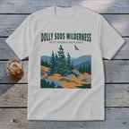 A light grey t-shirt featuring a green graphic of the Dolly Sods Wilderness with mountains, pine trees, and a flying bird.