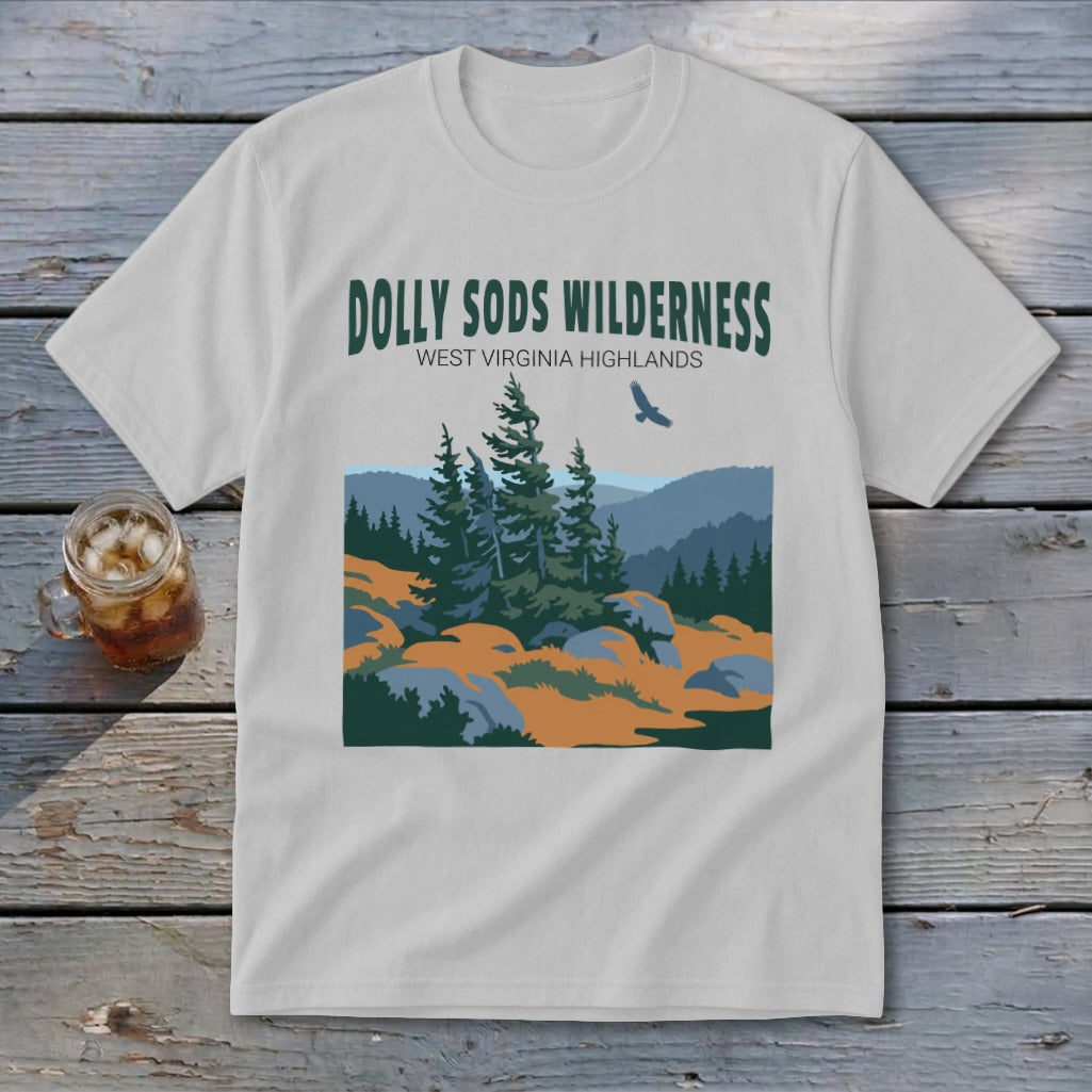A light grey t-shirt featuring a green graphic of the Dolly Sods Wilderness with mountains, pine trees, and a flying bird.