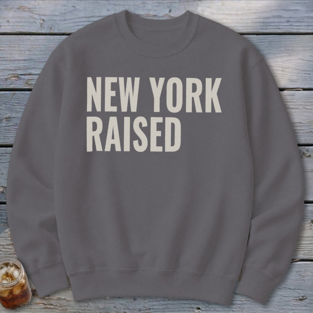 Gray sweatshirt with "NEW YORK RAISED" text in off-white.