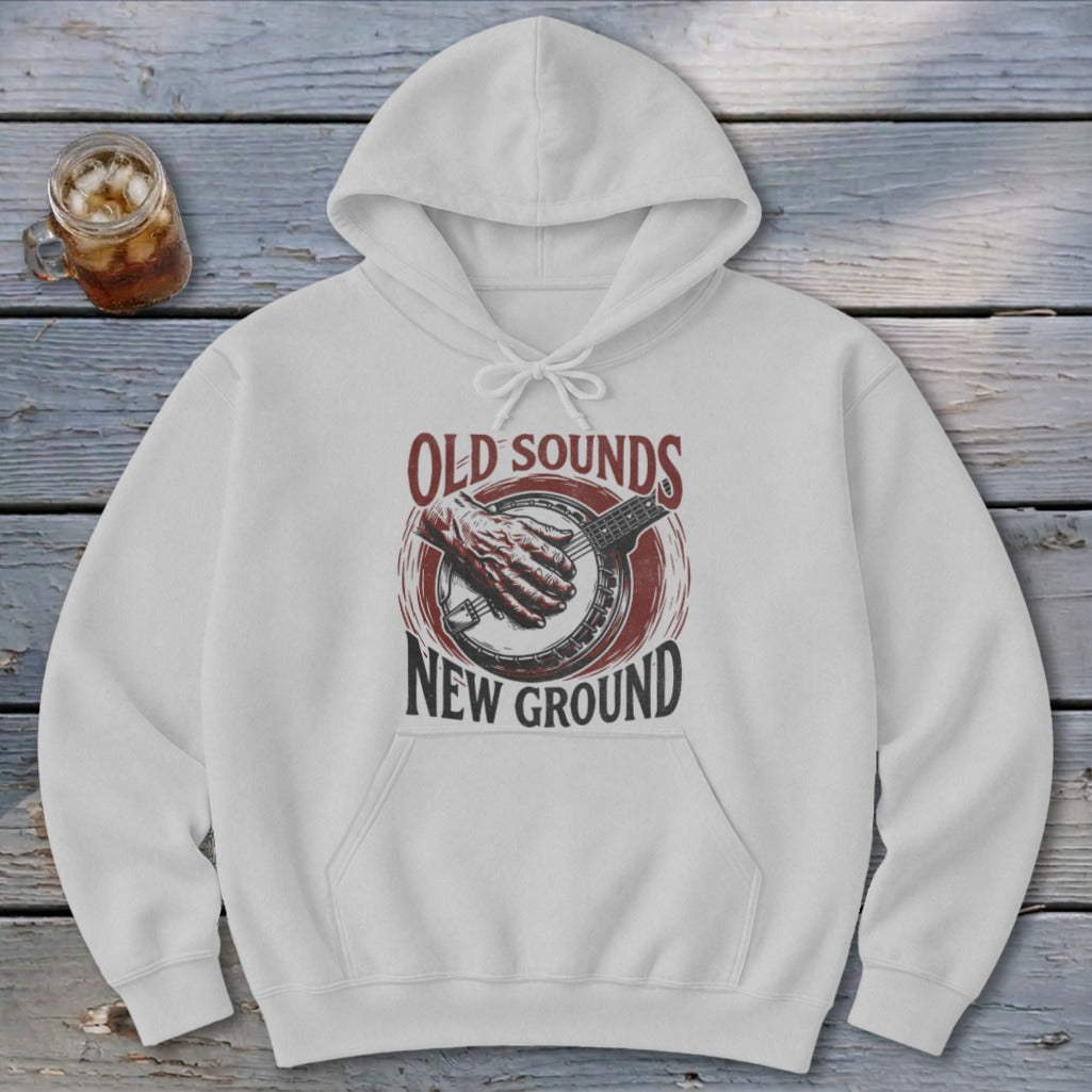 Light gray hoodie with a front graphic of a hand playing a banjo and text reading OLD SOUNDS NEW GROUND.