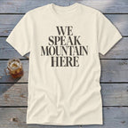 Cream t-shirt with black text that reads "WE SPEAK MOUNTAIN HERE".