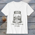 A white V-neck t-shirt featuring a mason jar graphic containing a mountain landscape, with text underneath reading "Carry the mountains with you".