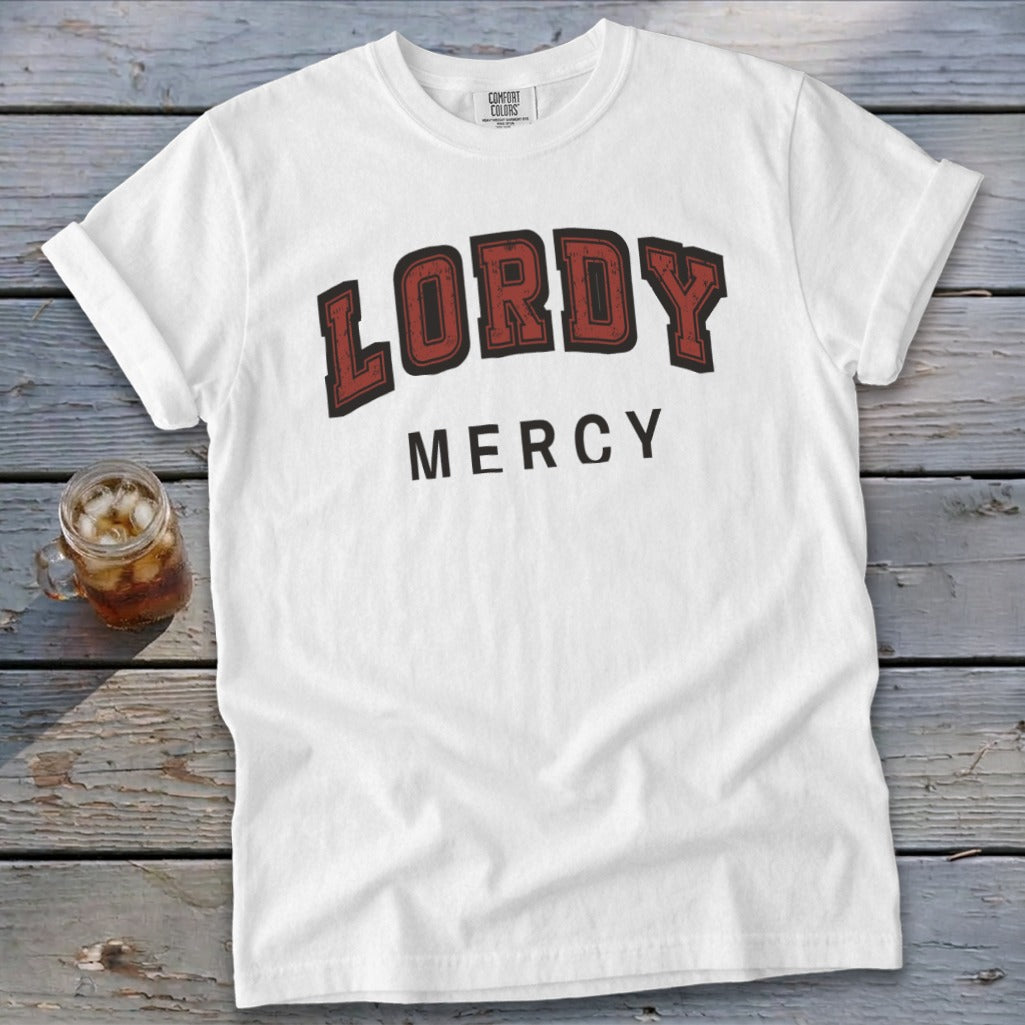 White t-shirt with "LORDY MERCY" text in arched dark red and black lettering.