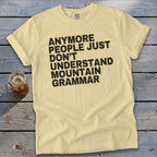 Pale yellow t-shirt with "ANYMORE PEOPLE JUST DON'T UNDERSTAND MOUNTAIN GRAMMAR" text.