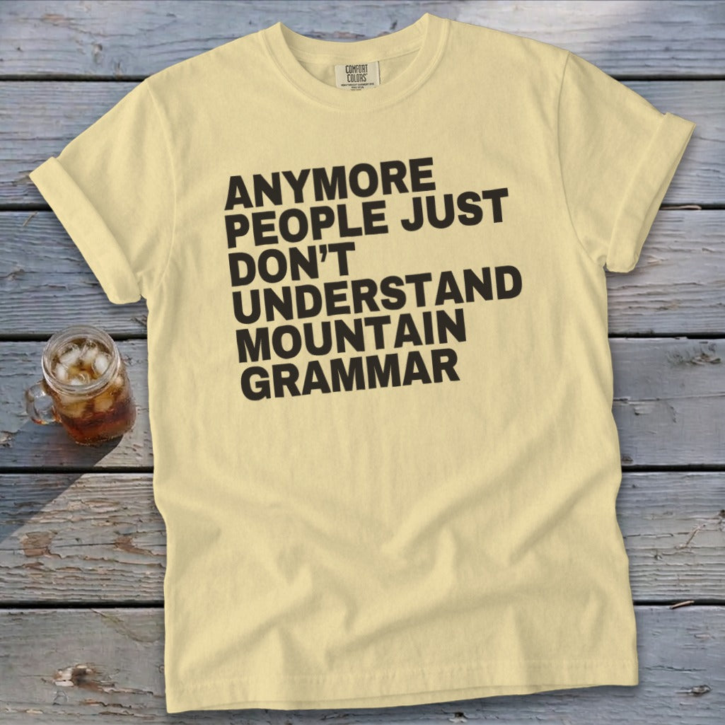 Pale yellow t-shirt with "ANYMORE PEOPLE JUST DON'T UNDERSTAND MOUNTAIN GRAMMAR" text.