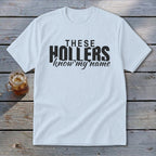 White t-shirt with black text reading "THESE HOLLERS know my name."