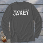 Dark grey long sleeve shirt with white text: "LOOKING A LITTLE JAKEY"