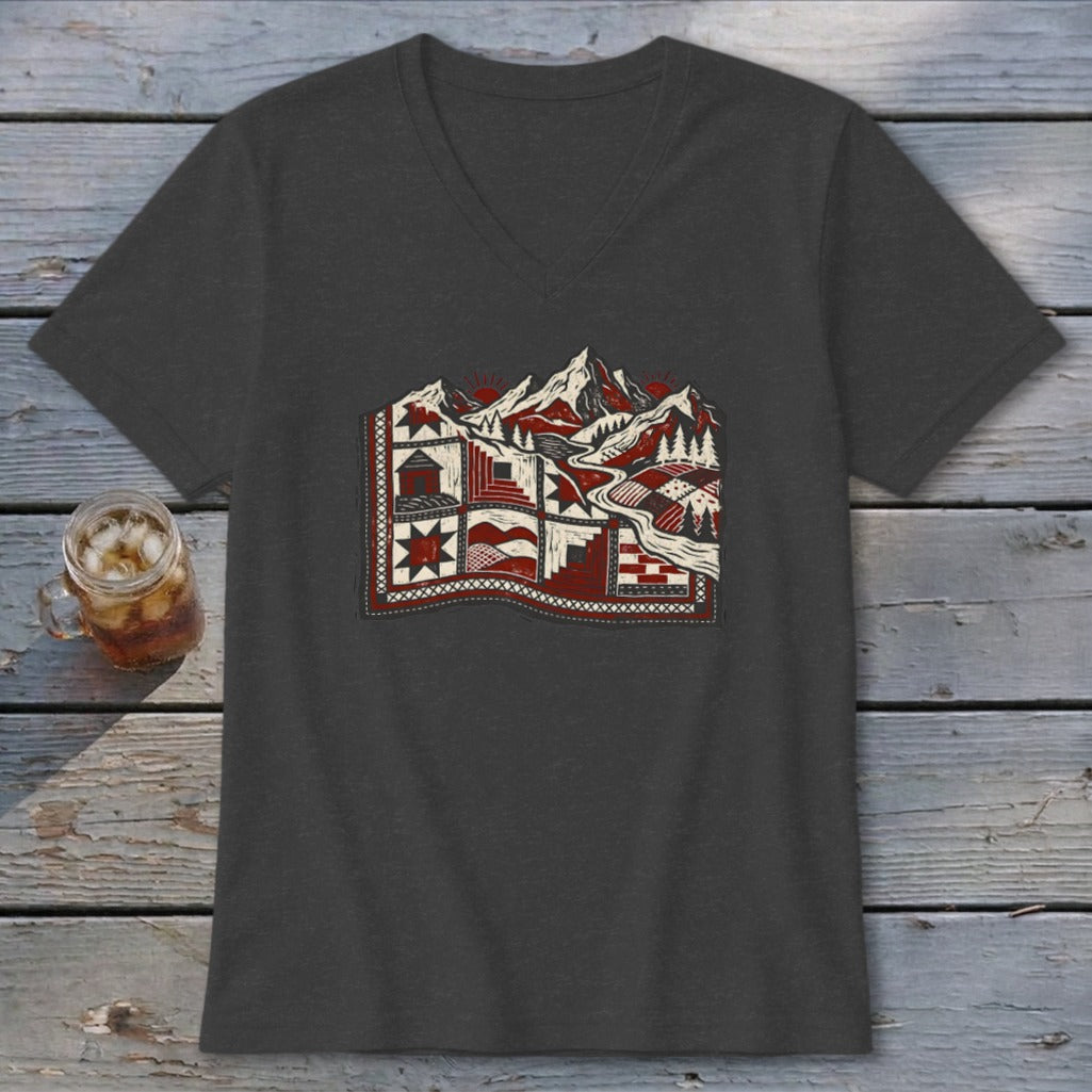Charcoal v-neck t-shirt featuring a stylized graphic of mountains, trees, and a quilt design in red, white, and black.