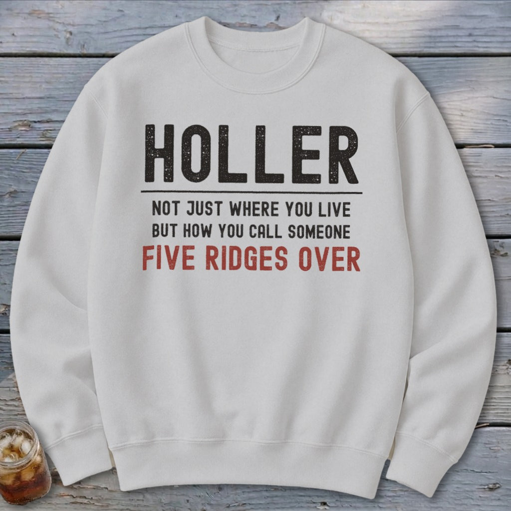 White sweatshirt with text "Holler. Not just where you live but how you call someone five ridges over."