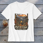 White t-shirt with "Pull up a chair" and "The holler's talkin'" text.