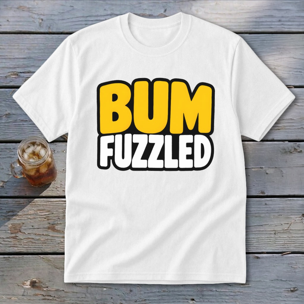 A white t-shirt featuring the text BUM FUZZLED on a wooden surface.