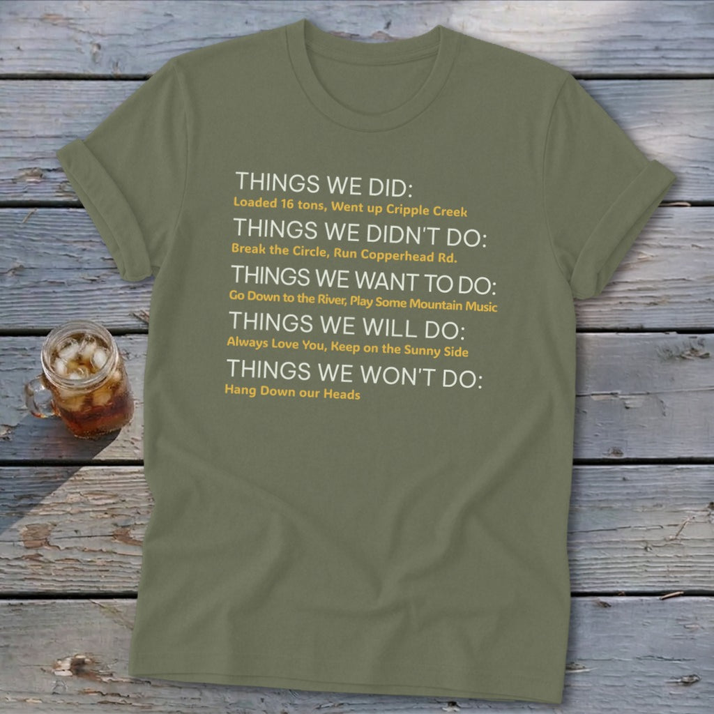 Olive green t-shirt with white and yellow text listing "Things We Did," "Didn't Do," "Want to Do," "Will Do," and "Won't Do."