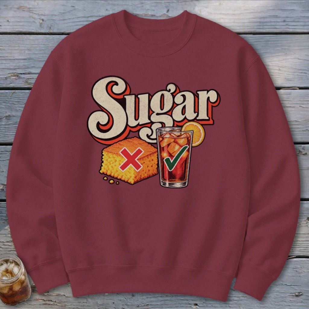Maroon crewneck sweatshirt featuring a retro graphic with the word Sugar, cornbread with a red X, and iced tea with a green checkmark.