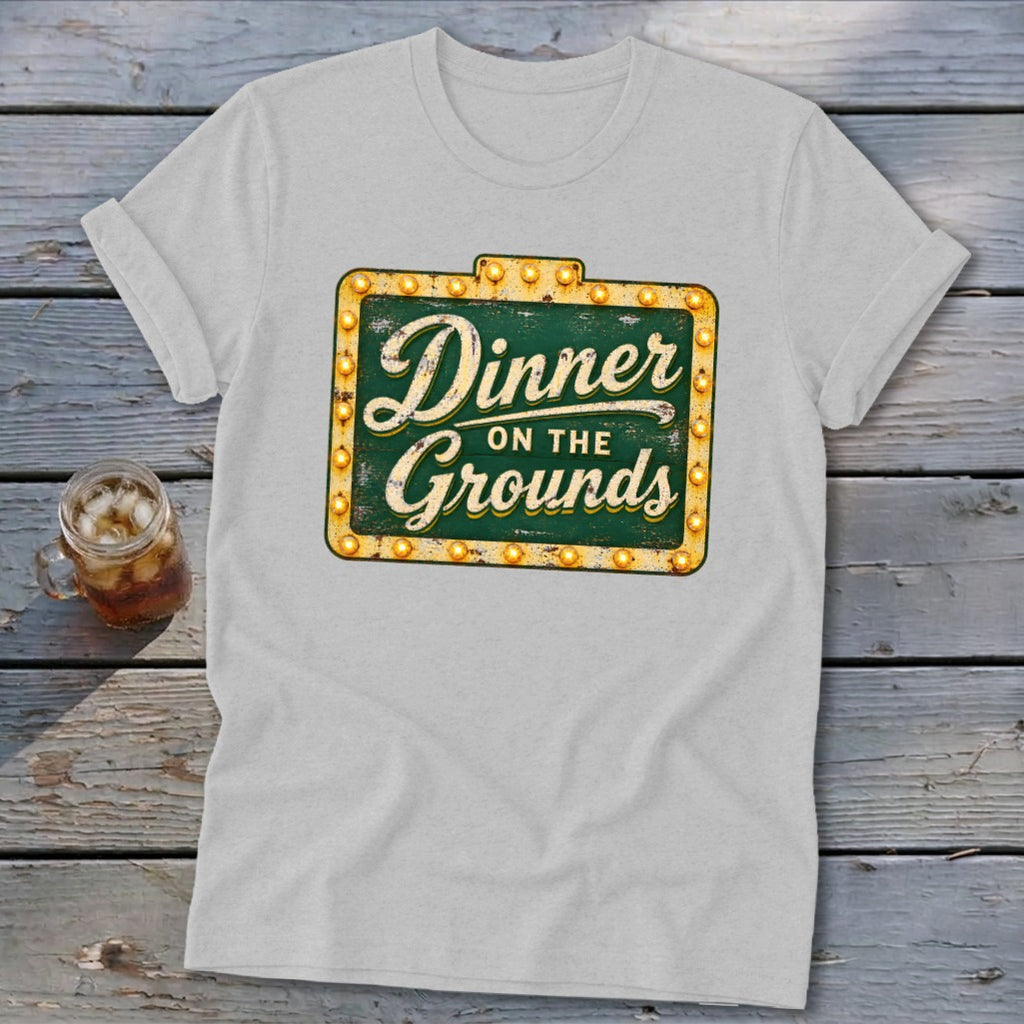 Light gray t-shirt with a vintage green and yellow sign graphic that reads Dinner on the Grounds.