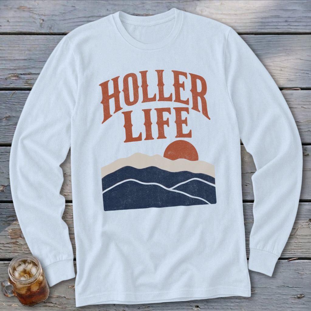 White long-sleeved t-shirt featuring the text HOLLER LIFE above a sunset over mountain ranges.