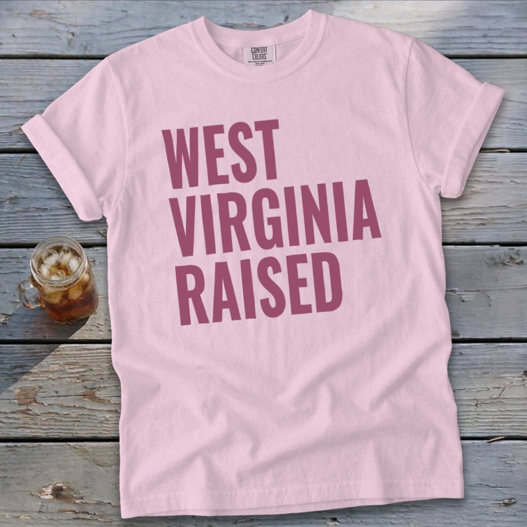 Light pink t-shirt with "West Virginia Raised" in maroon text.