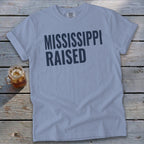 Light blue t-shirt with "MISSISSIPPI RAISED" text and a glass of iced tea.
