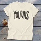 Cream t-shirt with "YOU'UNS" in dark gray bold text.