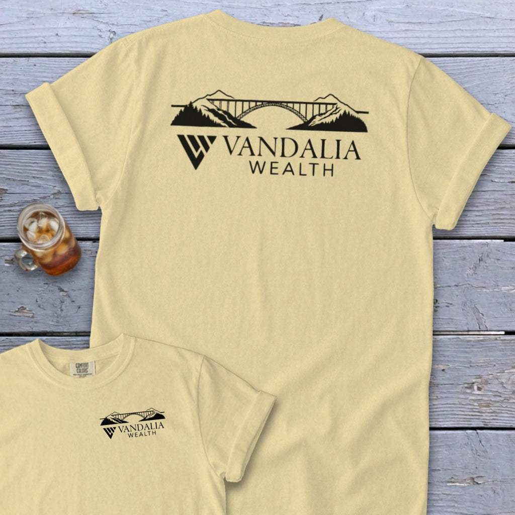 Yellow t-shirt with a black mountain and bridge logo, "VANDALIA WEALTH" text.