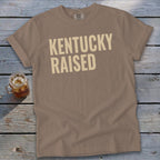 Brown t-shirt with "KENTUCKY RAISED" text and a glass of iced tea.
