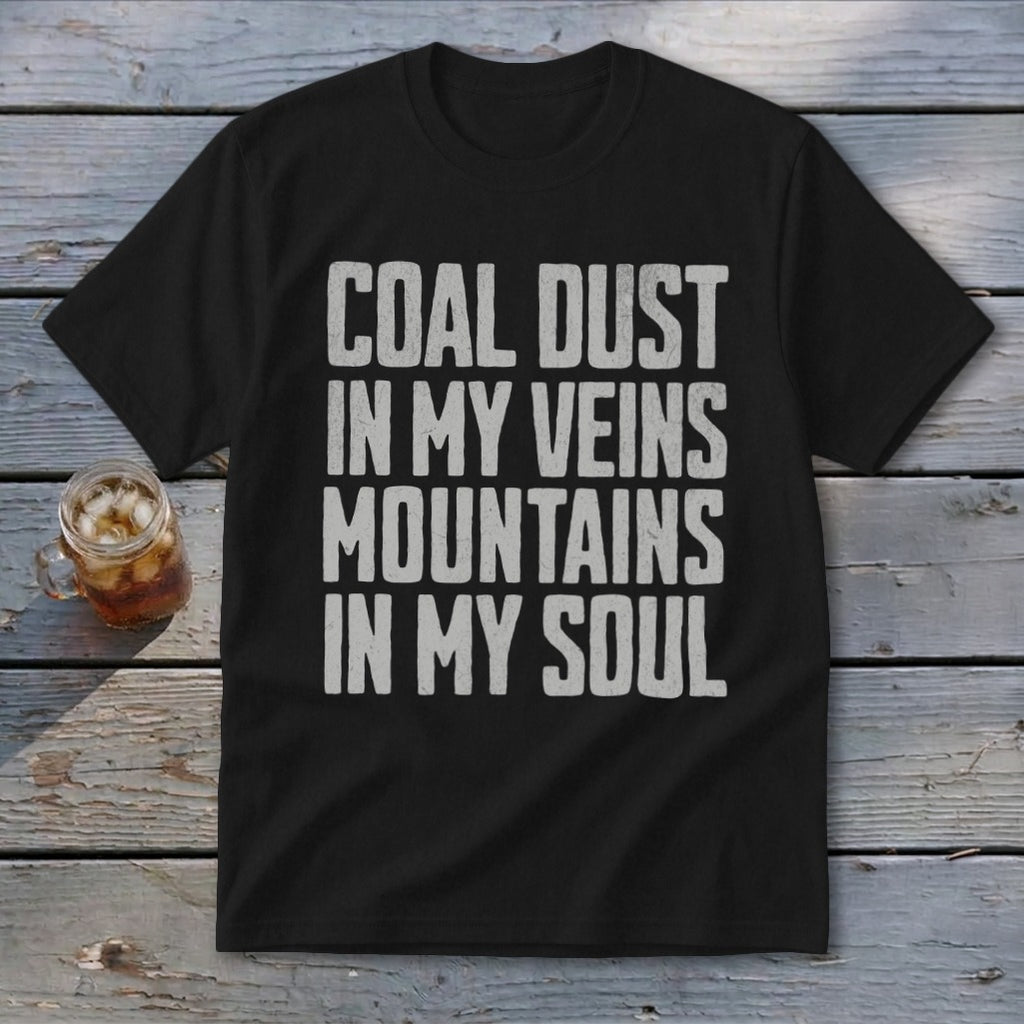 A black t-shirt with white distressed text that reads COAL DUST IN MY VEINS MOUNTAINS IN MY SOUL.