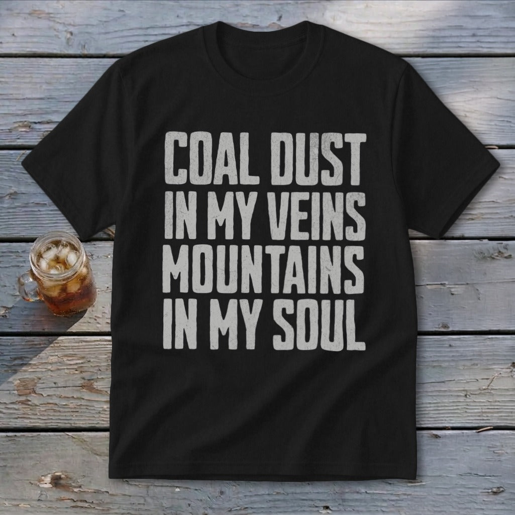 A black t-shirt with white distressed text that reads COAL DUST IN MY VEINS MOUNTAINS IN MY SOUL.