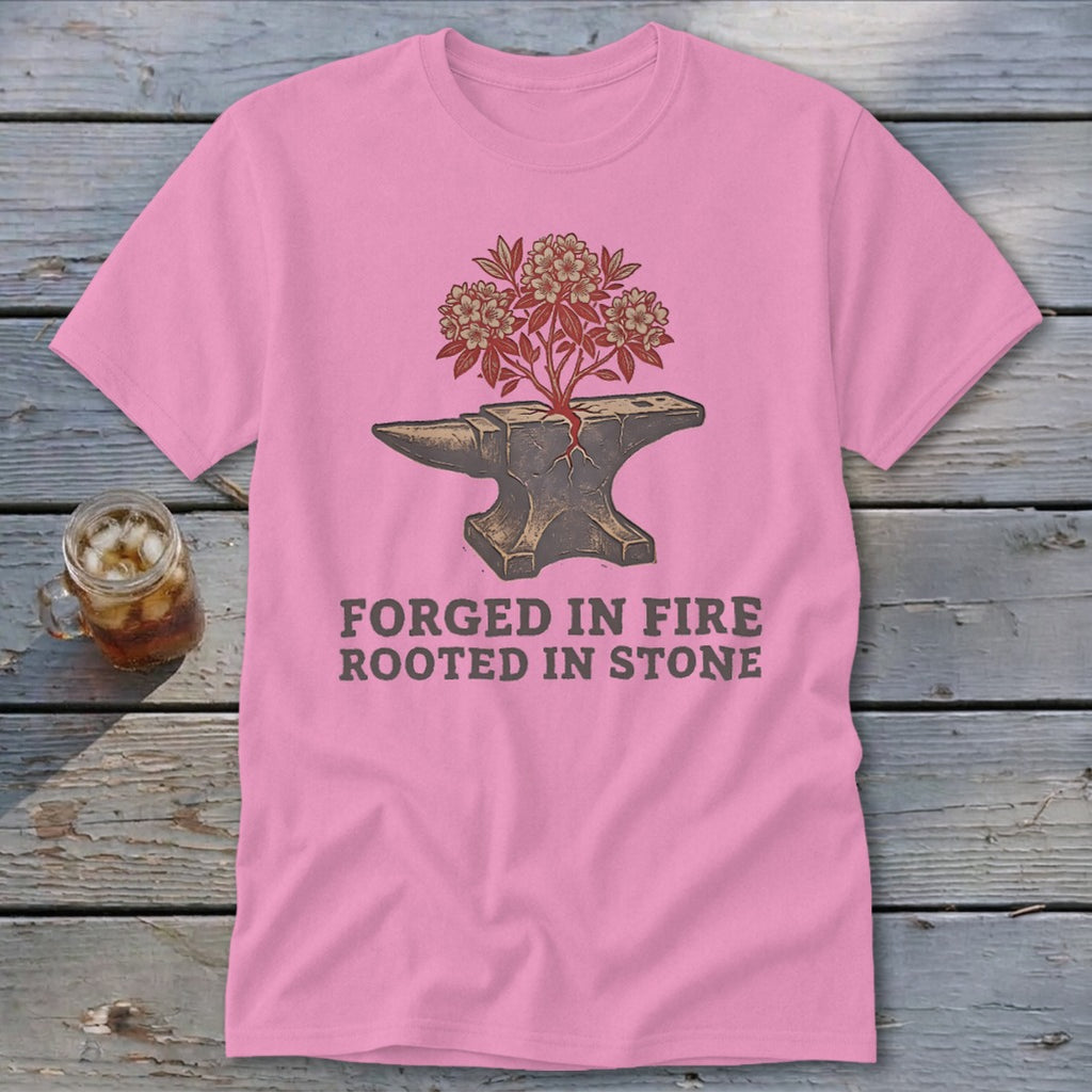 Pink t-shirt with anvil, blooming tree, and text "FORGED IN FIRE ROOTED IN STONE".
