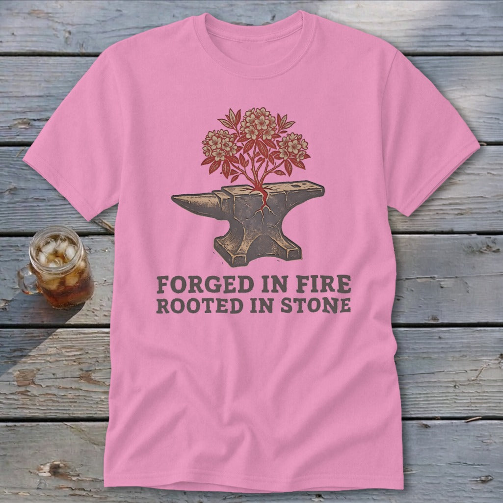 Pink t-shirt with anvil, blooming tree, and text "FORGED IN FIRE ROOTED IN STONE".