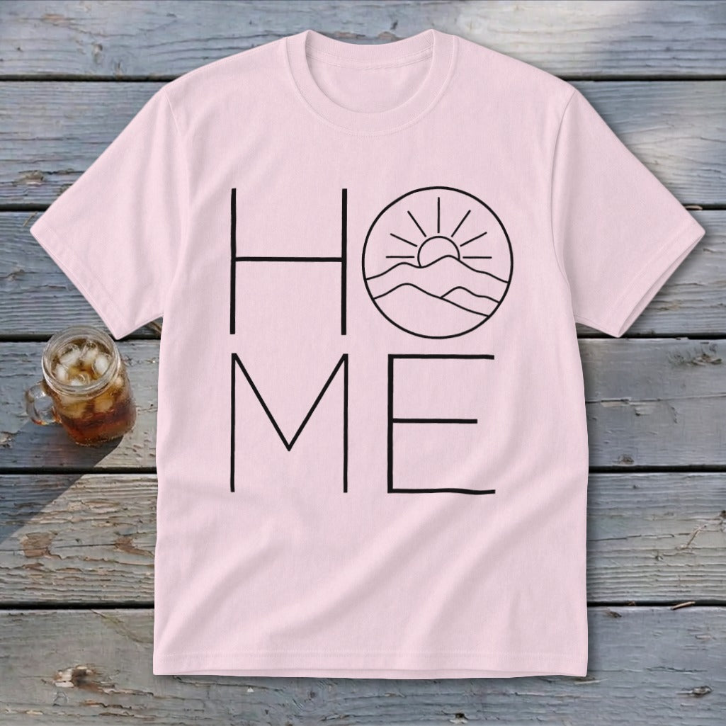 Light pink t-shirt displaying a black line art graphic of mountains and sun substituting for the letter O in the word HOME.