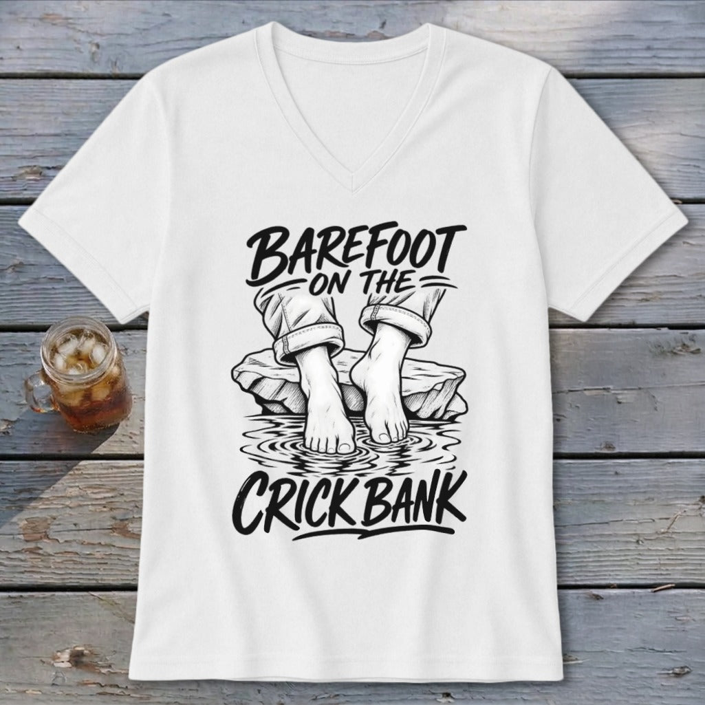 White t-shirt with black graphic of bare feet on rocks in water, reading "Barefoot on the Crick Bank."