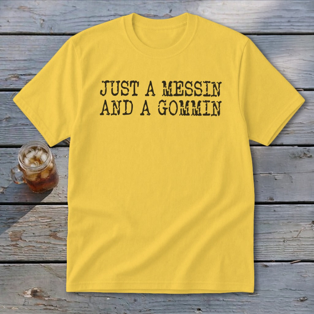 Yellow t-shirt with black text "JUST A MESSIN AND A GOMMIN".