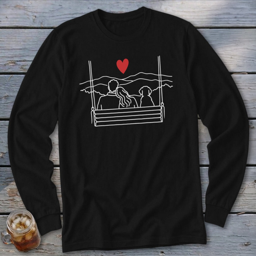 Black long-sleeve shirt with a white outline graphic of a couple and dog on a swing.