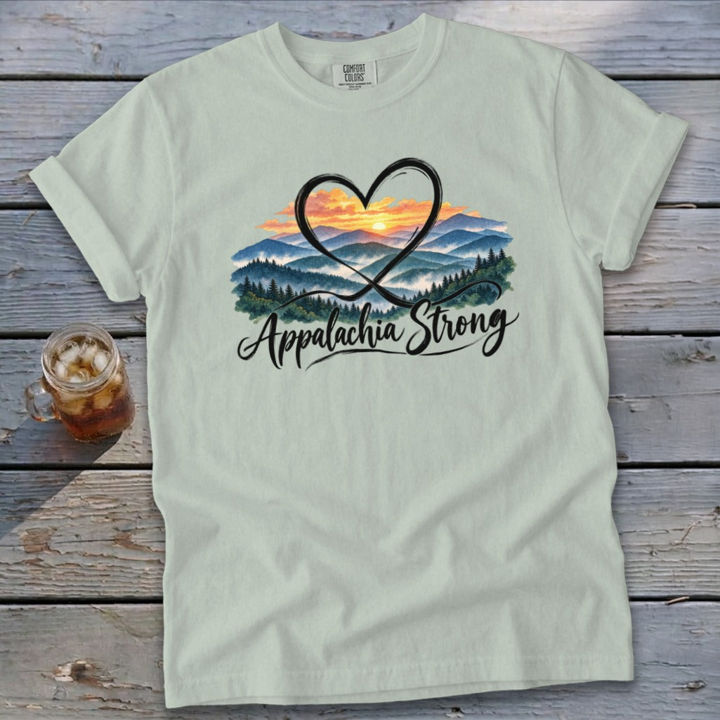 Light green t-shirt with a heart framing a mountain sunrise and "Appalachia Strong" text.