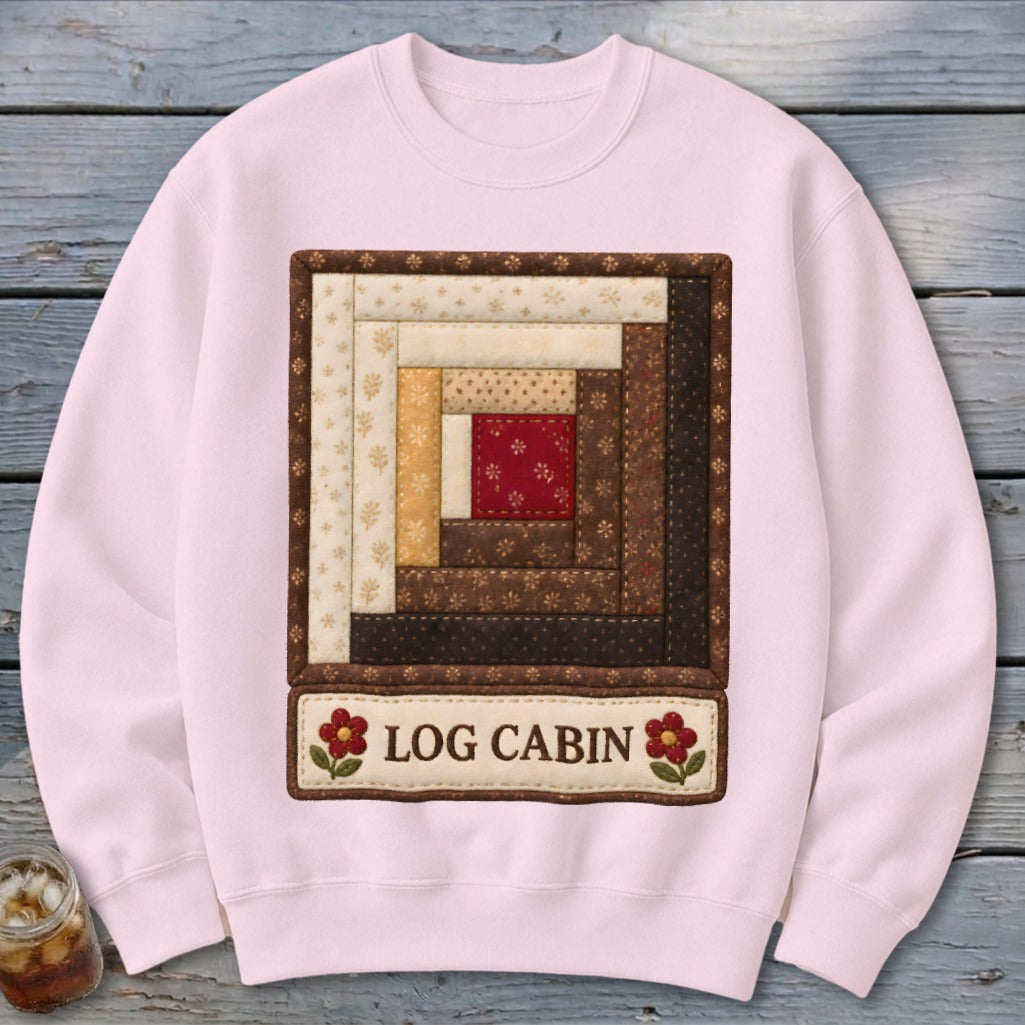 Pink sweatshirt with a "Log Cabin" quilt design and text.