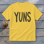 Yellow t-shirt with dark brown text "YUNS" centered on the chest.