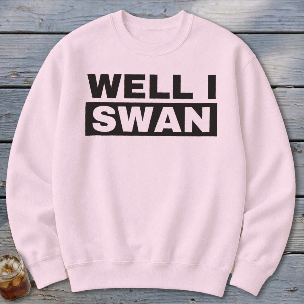Light pink crewneck sweatshirt with the black text WELL I SWAN printed across the chest.