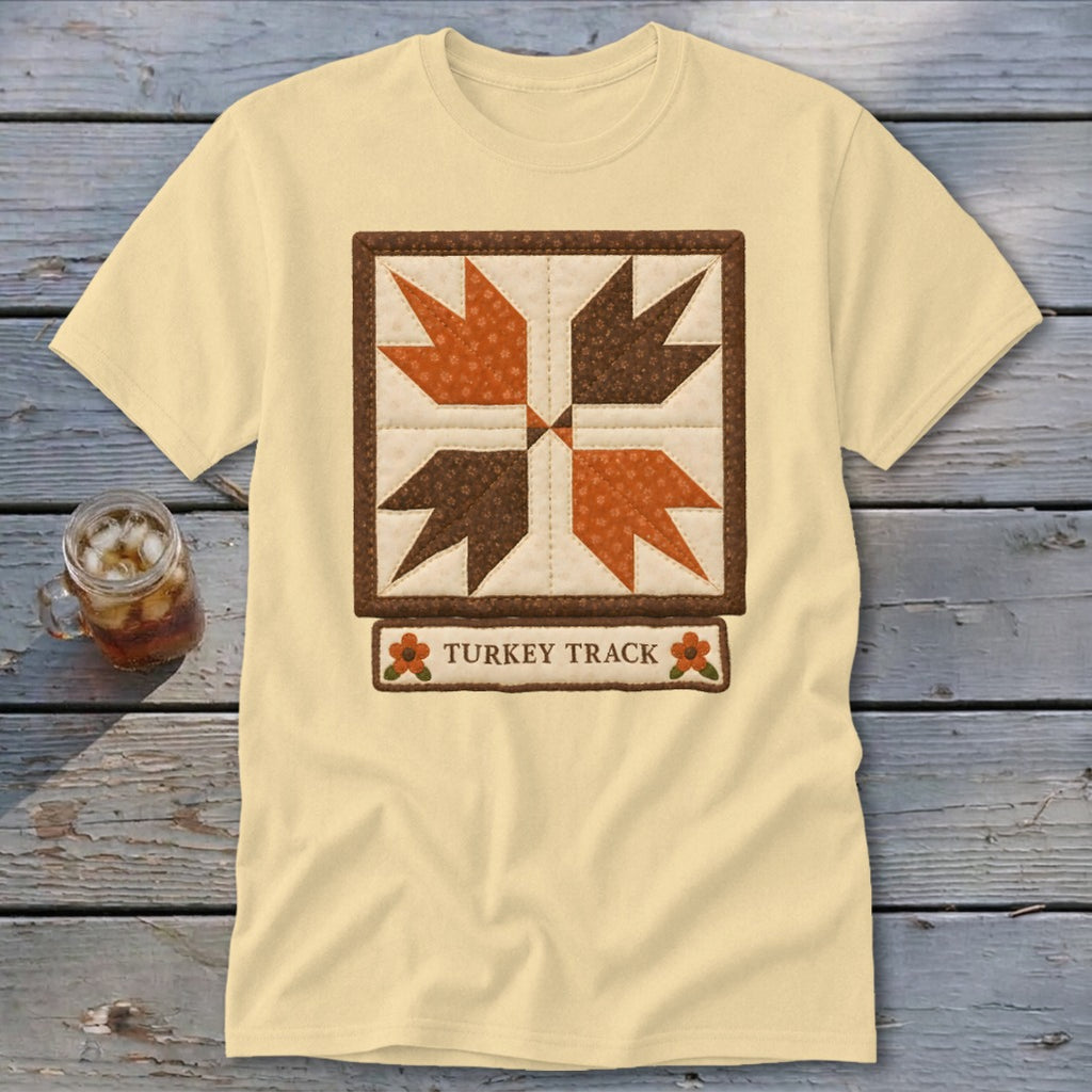 Cream t-shirt with a quilted "Turkey Track" design and autumnal colors.