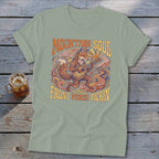 Light green t-shirt with a stylized fox playing a guitar and "Mountain Soul and Front Porch Pickin" text.