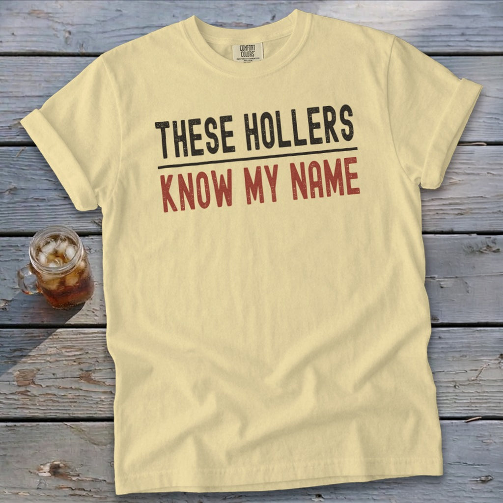 Light yellow t-shirt with "THESE HOLLERS KNOW MY NAME" text.