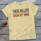 Light yellow t-shirt with "THESE HOLLERS KNOW MY NAME" text.