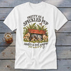 T-shirt with speckled puppy sleeping under a red wagon with ferns and mushrooms.