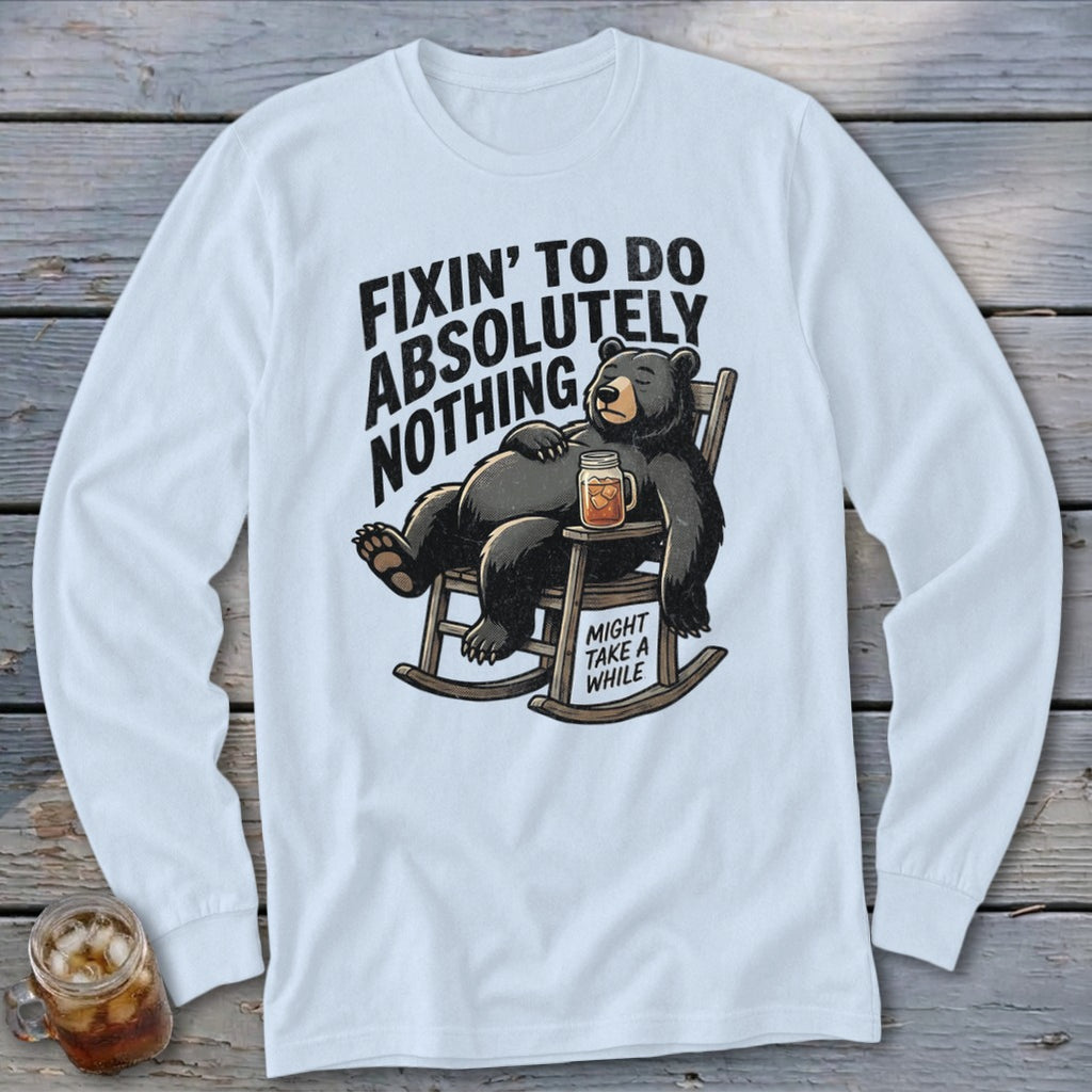 White long-sleeved shirt with a graphic of a bear in a rocking chair, accompanied by humorous text.
